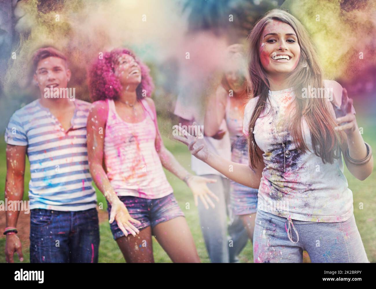Color Me FUN. Aufnahme von glücklichen Freunden, die Spaß mit Pulverfarbe haben. Stockfoto