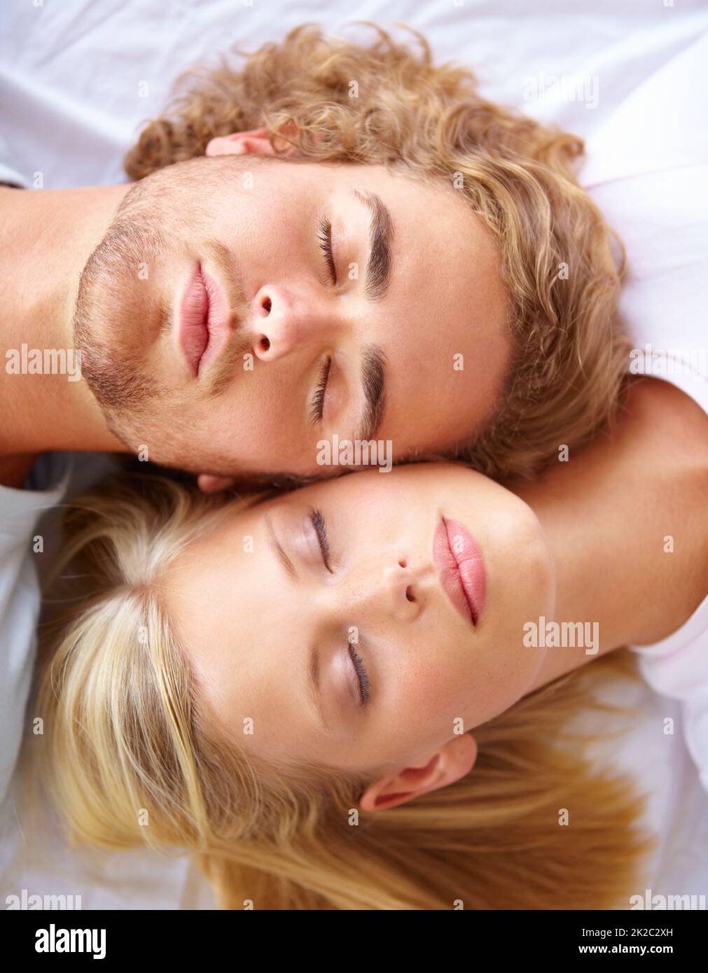 Ruhe und Entspannung. Ein junges Paar schläft im Bett mit ihren Köpfen zusammen. Stockfoto