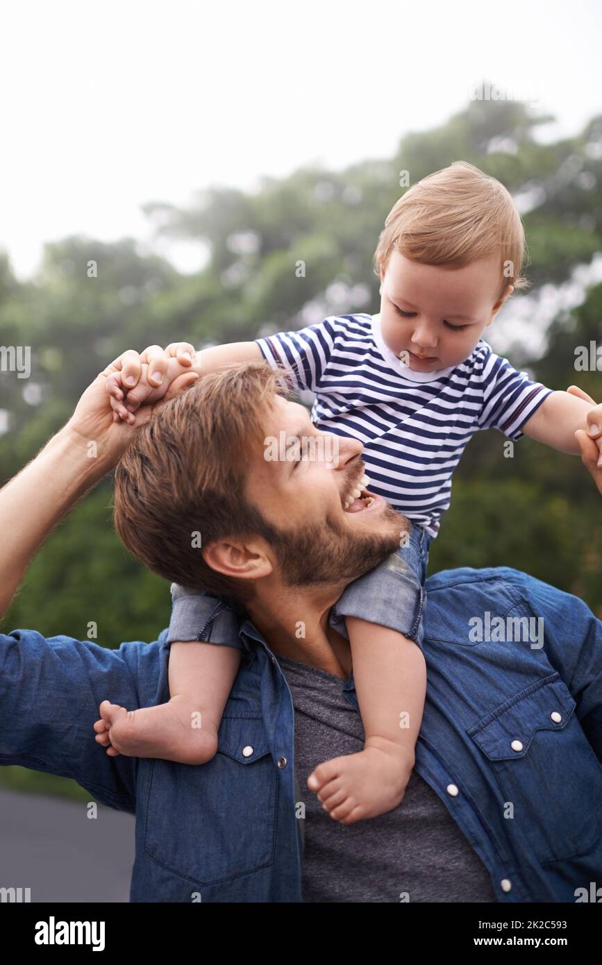 Lustige Zeiten mit Papa. Aufnahme des jungen Vaters und seines kleinen Jungen, die einen Tag draußen genießen. Stockfoto