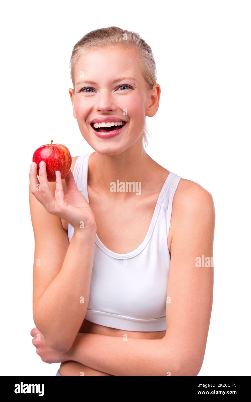 Eines pro Tag. Porträt einer schönen jungen Frau, die einen Apfel in der Hand hält. Stockfoto