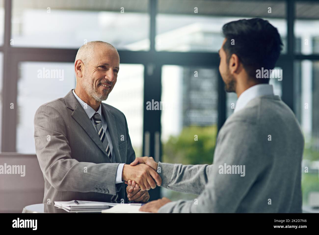 Freut mich, Sie an Bord zu haben. Eine kurze Aufnahme von zwei Geschäftsleuten, die in einem Büro die Hände schütteln. Stockfoto