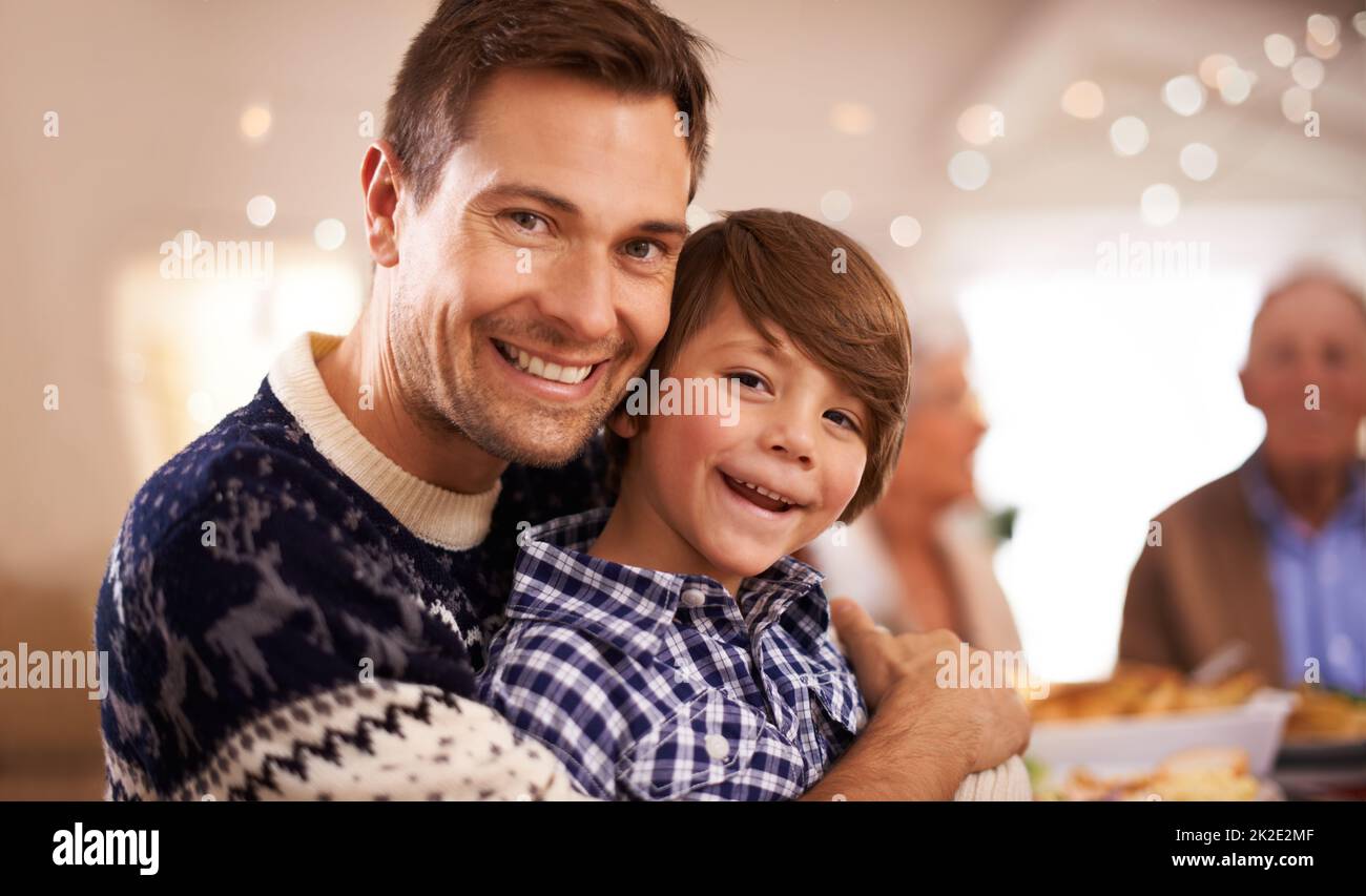 Weihnachten ist in diesem Haus Tradition. Porträt eines jungen Vaters und seines Sohnes am Weihnachtstag. Stockfoto
