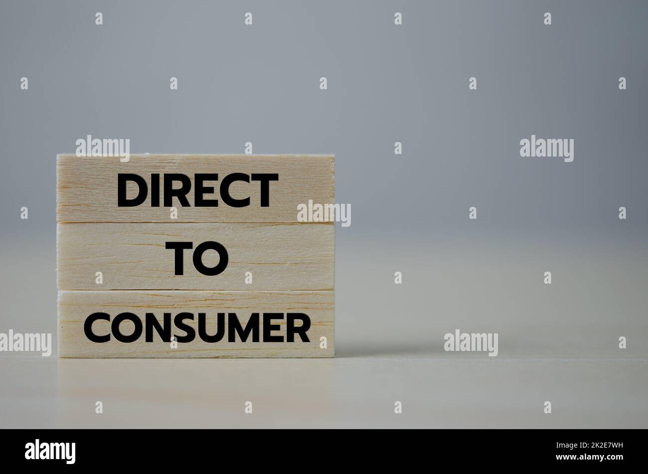 Holzwürfelblock Icon direkt an Consumer D2C auf dem Tisch.Business Marketing Konzept. Stockfoto