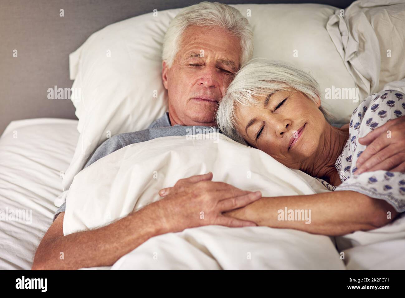 Momente wie diese sind unbezahlbar. Aufnahme eines älteren Paares, das im Bett schlief. Stockfoto