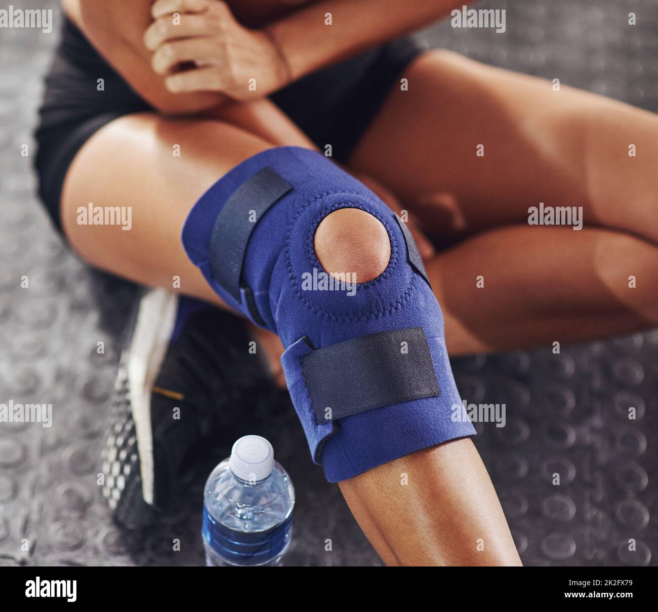 Umgang mit Verletzungen. Aufnahme einer Sportlerin mit Kniestütze. Stockfoto