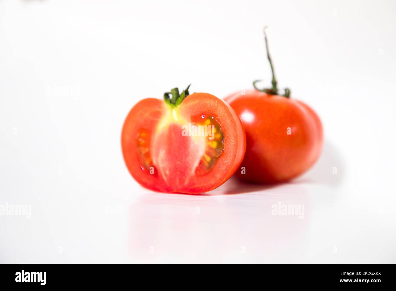 Frische rote Tomatenstücke isoliert im Hintergrund Stockfoto