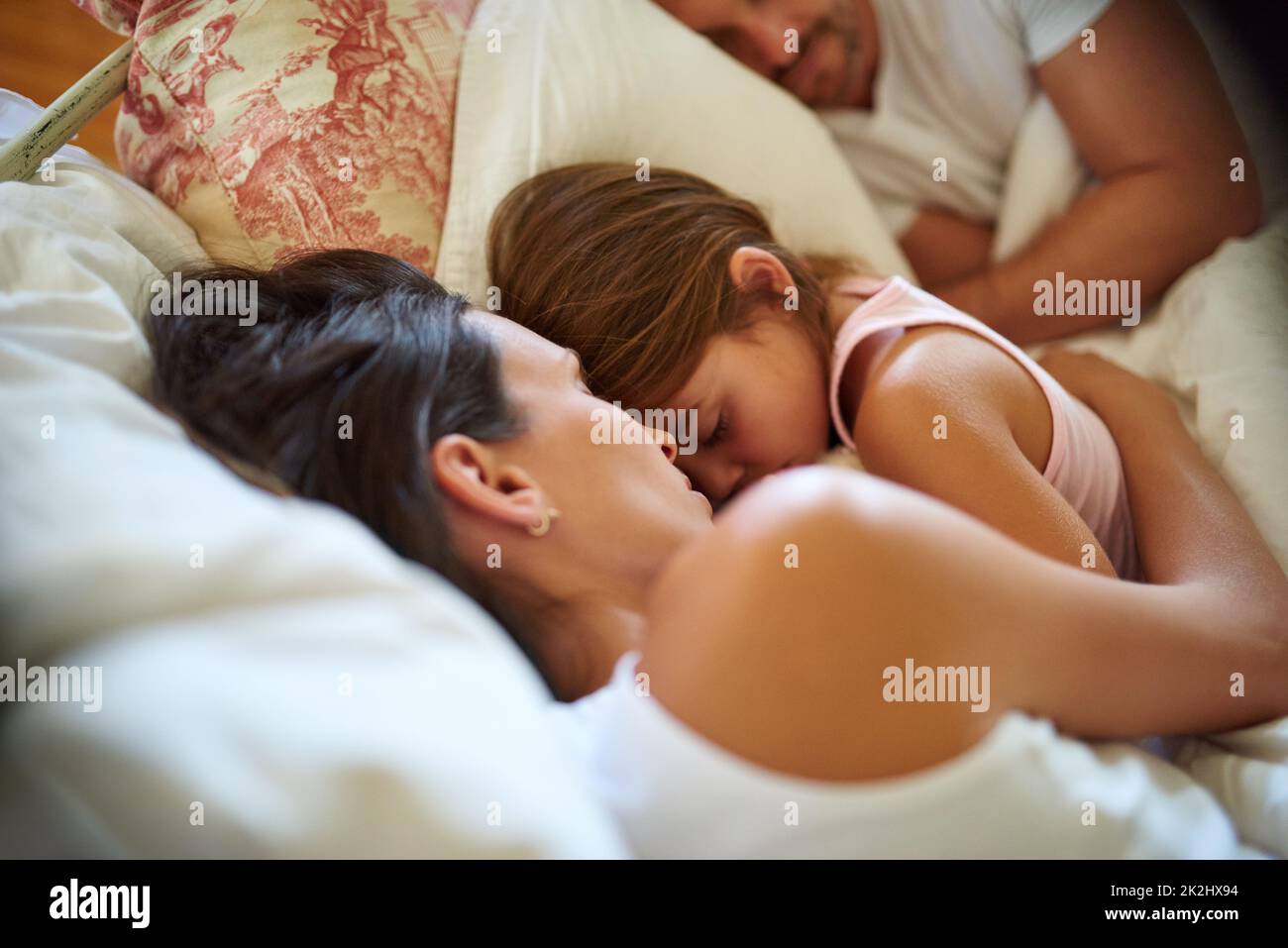 Familie kuscheln sich Zeit. Aufnahme einer Familie, die zu Hause im Bett schläft. Stockfoto