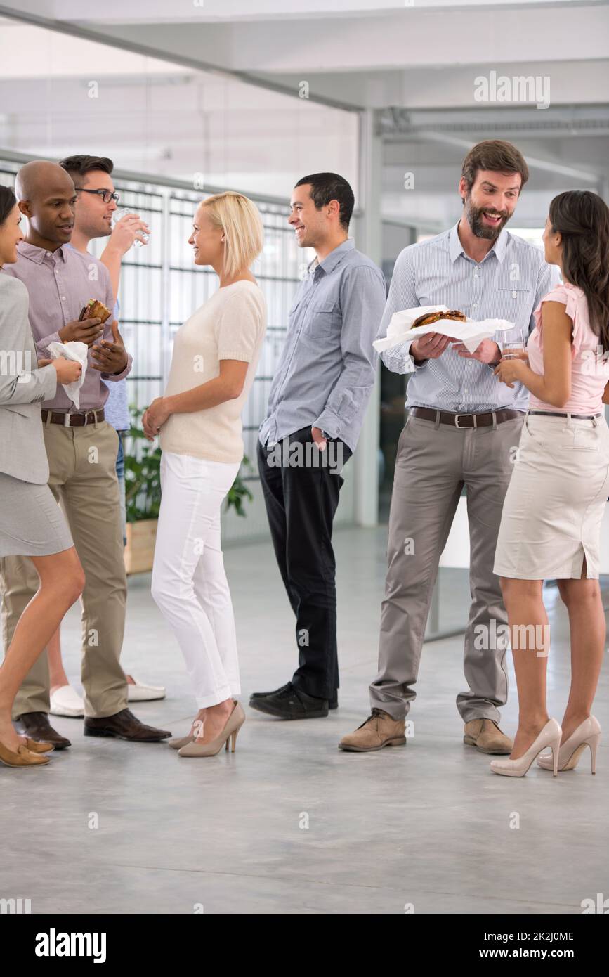 Chatten mit Kollegen. Aufnahme einer Gruppe von Kollegen, die zusammen ein informelles Mittagessen genießen. Stockfoto