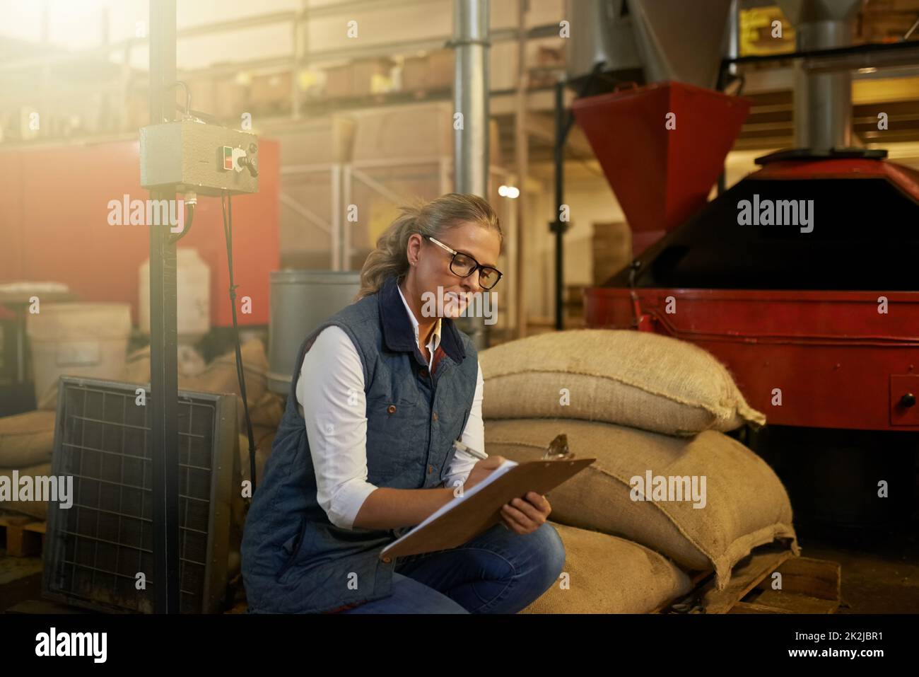 Auf den täglichen Weg. Aufnahme einer fleißigen Unternehmerin, die allein in ihrer Kaffeerösterei arbeitet. Stockfoto