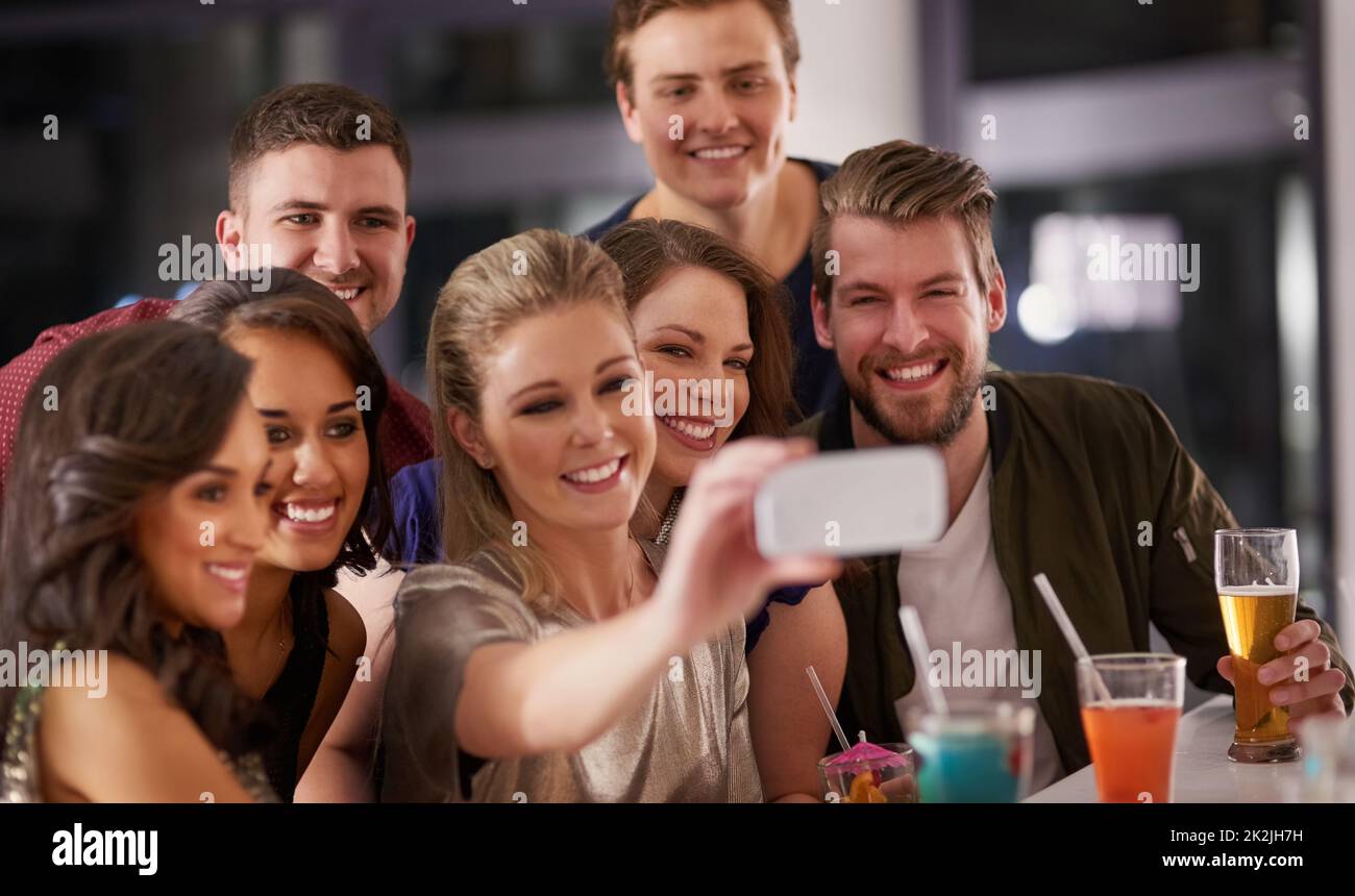 Wir brauchen keine Entschuldigung für ein Selfie. Aufnahme einer glücklichen Gruppe von Freunden, die ein Selfie machen, während sie zusammen an einer Bar einen Drink genießen. Stockfoto
