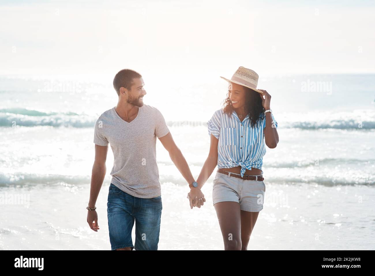 Ich bin so glücklich, dich in meinem Leben zu haben. Aufnahme eines jungen Paares, das am Strand entlang läuft. Stockfoto