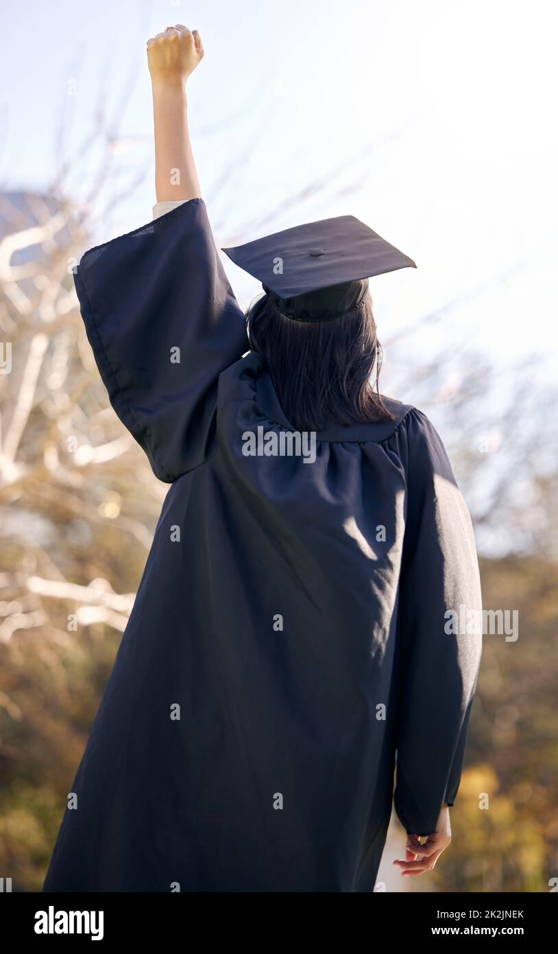 Sei mutig, sei dein alles, sei einfach dein Bestes. Rückansicht einer jungen Frau, die am Tag der Abschlussfeier jubelt. Stockfoto