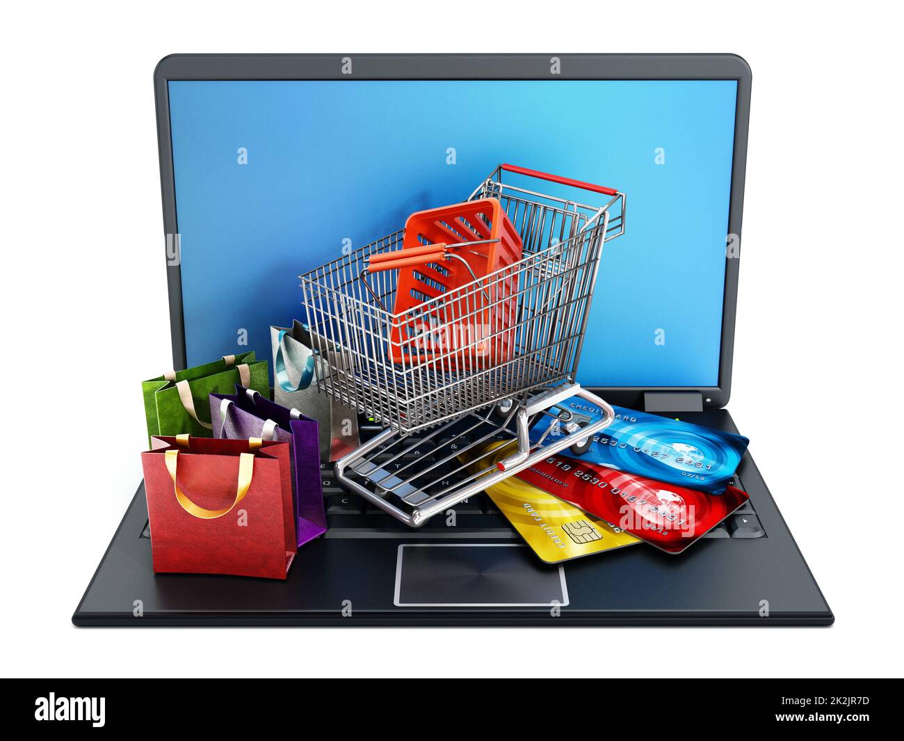 Einkaufswagen, Kreditkarten und Taschen stehen auf einem Laptop. Stockfoto