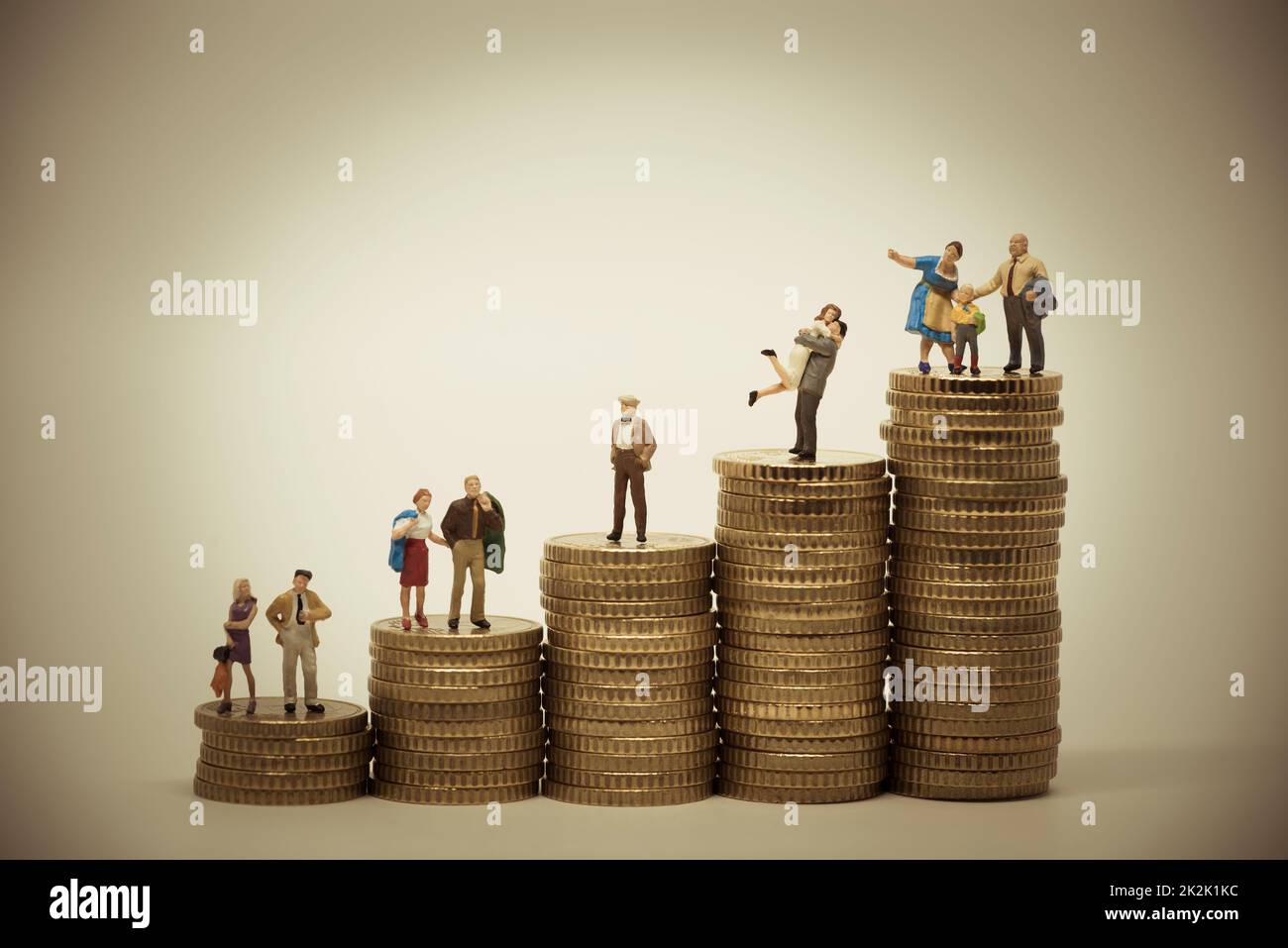 Das soziale Größenkonzept verschiedener Personen in verschiedenen Positionen auf Münzstapeln. Stockfoto