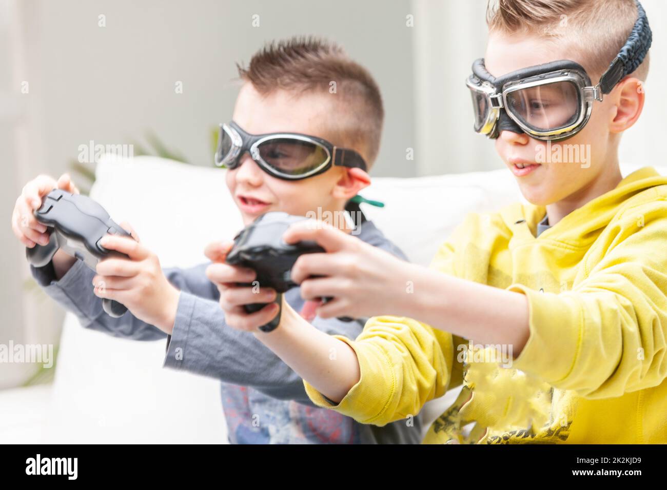 Zwei konkurrierende junge Jungs, die Computerspiele spielen Stockfoto