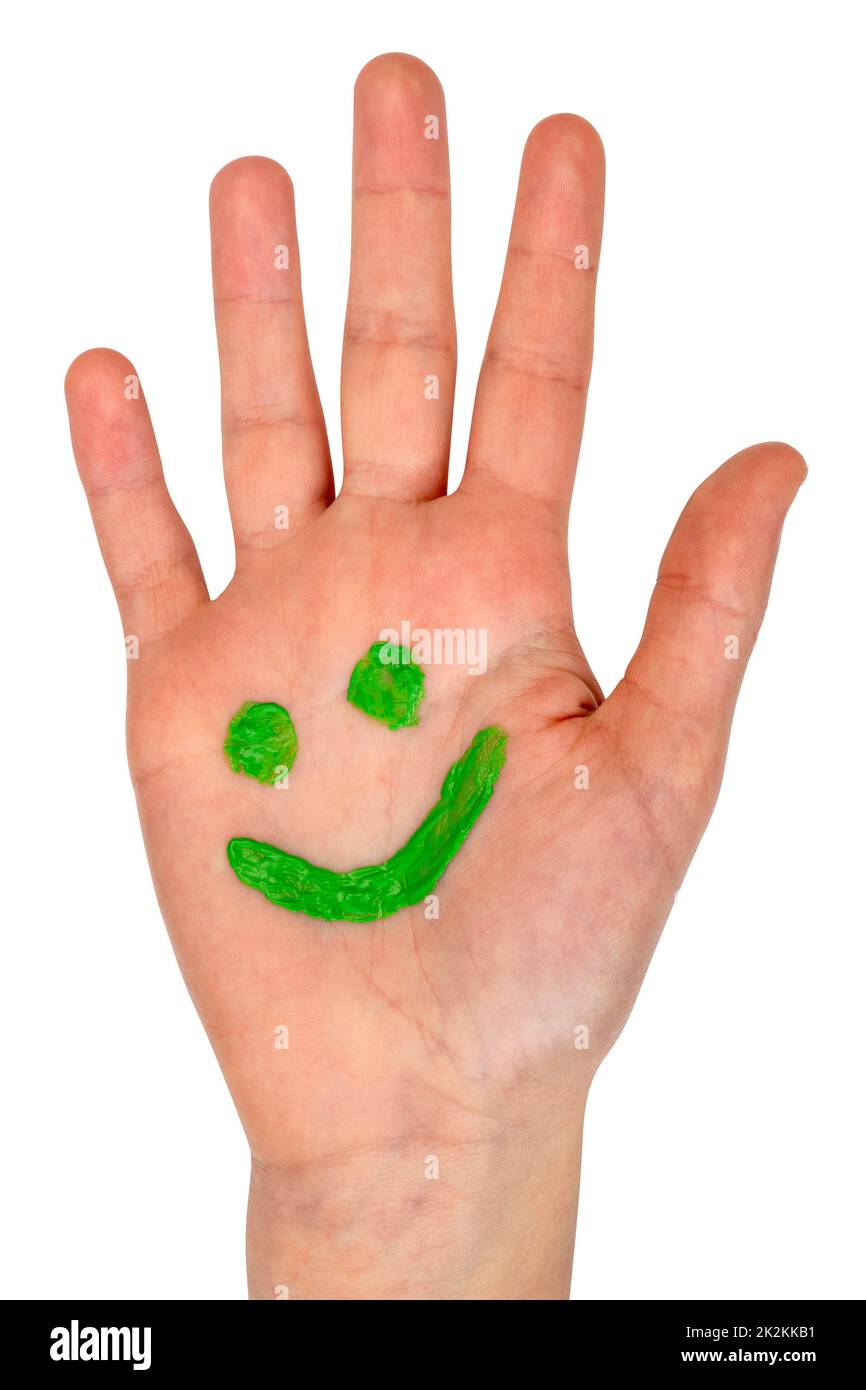 Grünes lächelndes Gesicht auf Kinderhandfläche gezeichnet Stockfoto