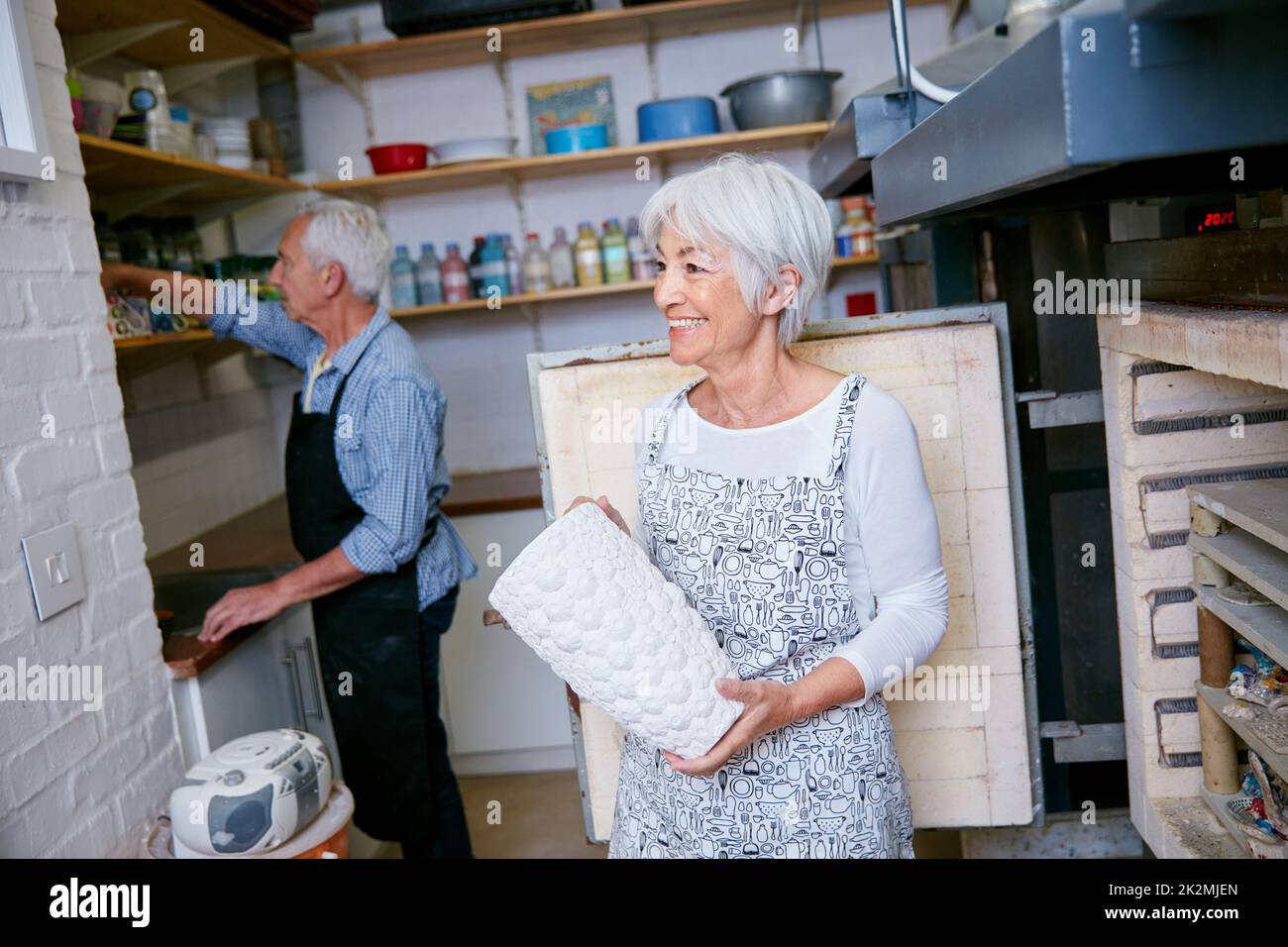 Zuhause ist, wo die Kunst ist. Aufnahme eines älteren Ehepaares, das in einer Werkstatt mit Keramik arbeitet. Stockfoto