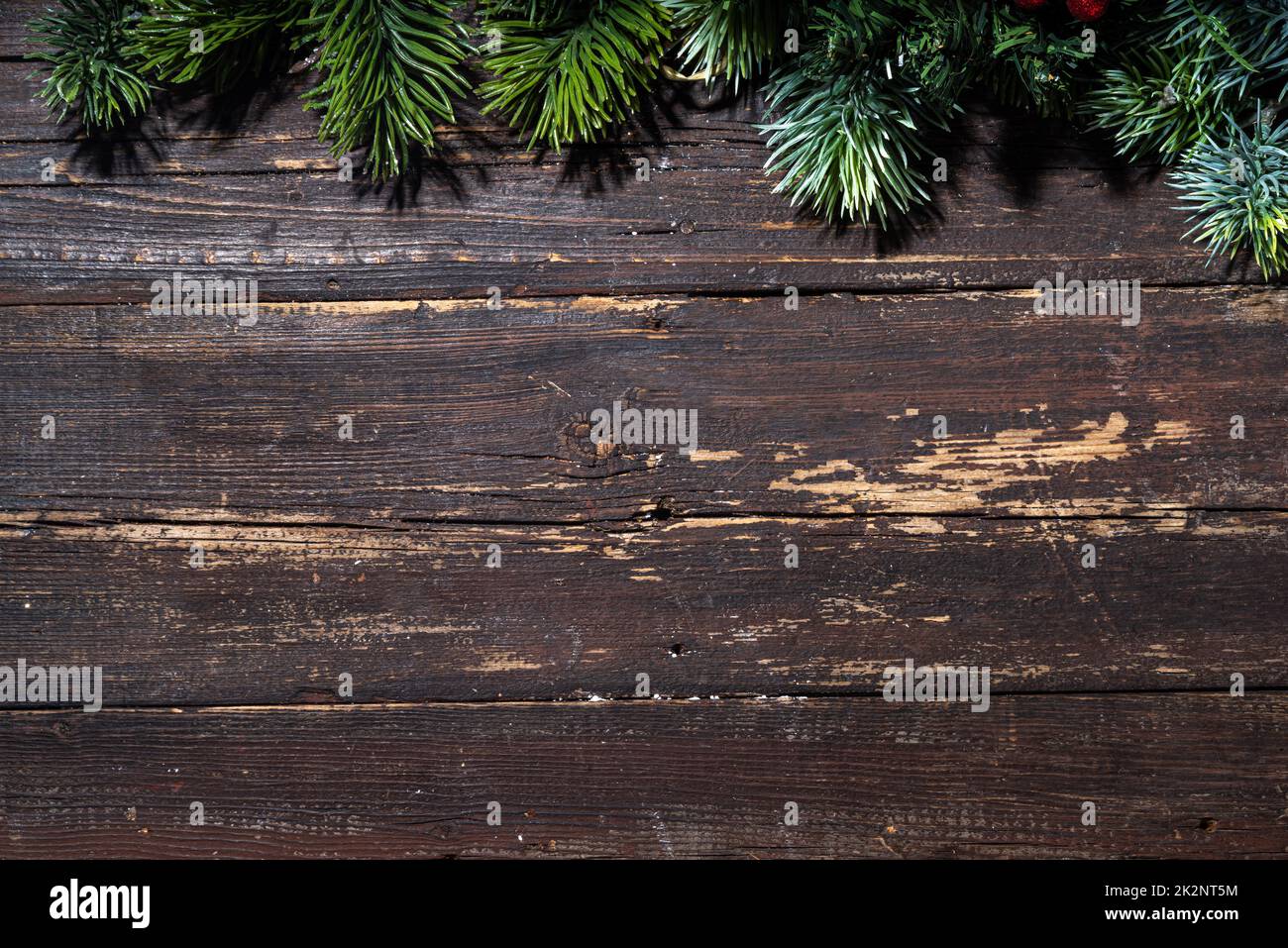 Weihnachten und Neujahr Grußkarte einfacher Hintergrund. Fichtenzweige auf dunklen alten rustikalen Holztisch Draufsicht kopieren Raum Stockfoto