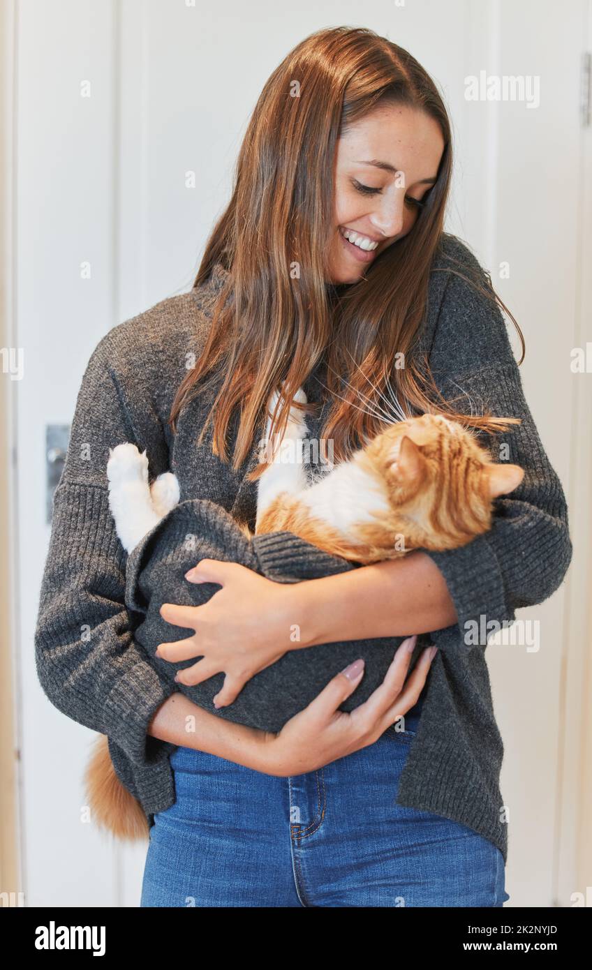 Ich möchte nur eine Stay-at-Home-Katze-Mutter sein. Aufnahme einer jungen Frau, die ihre Katze zu Hause trägt. Stockfoto