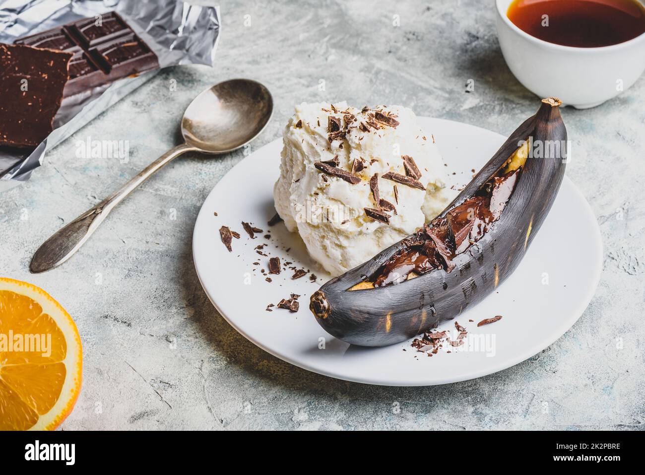Gegrillte Banane mit dunkler Schokolade und Vanilleeis. Stockfoto
