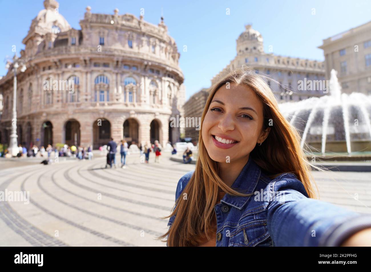 Junge lächelnde Frau, die in Genua, Italien, Selbstporträt macht Stockfoto
