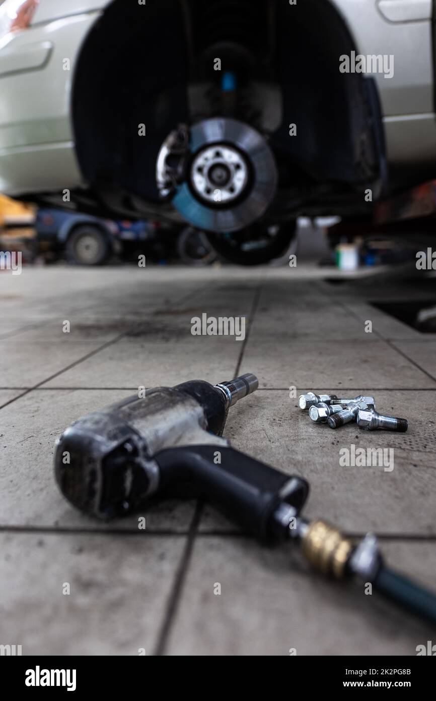 Fahrzeug in einer Garage für Wartung, Öl-/Reifenwechsel (flaches Bild mit DOF-Farbtönen) Stockfoto