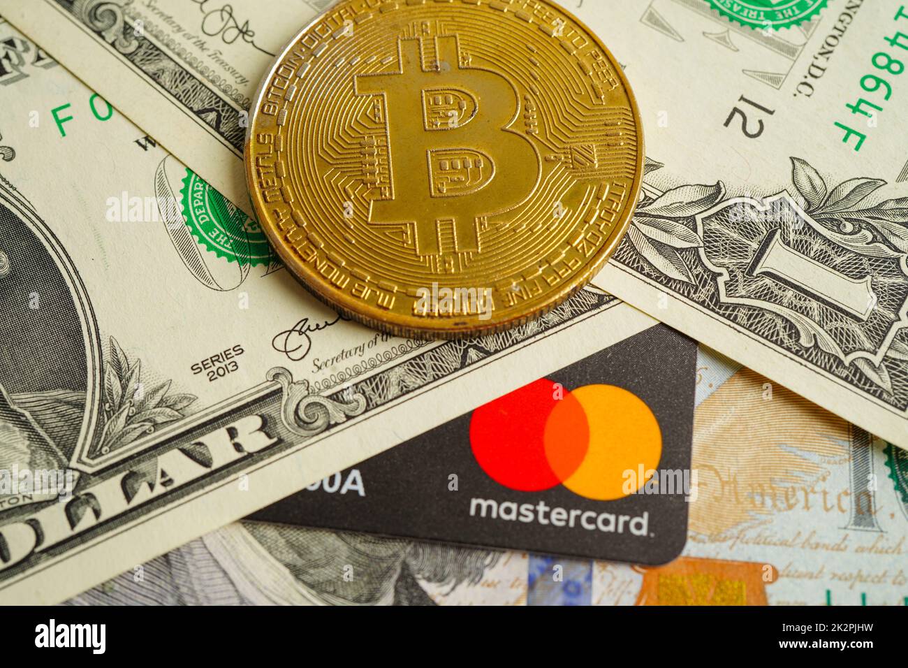 Bangkok, Thailand - 15. Dezember 2021 Goldene Bitmünze mit Kreditkarte auf US-Dollar-Banknoten Geld für Geschäfts- und Geschäftskunden, digitale Währung, virtuelle Kryptowährung. Stockfoto