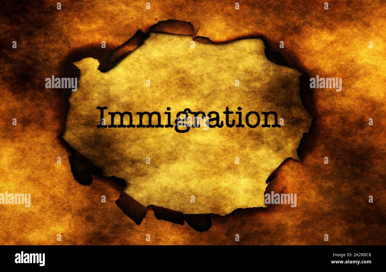 Einwanderung-Text auf brennenden Papier Loch Stockfoto