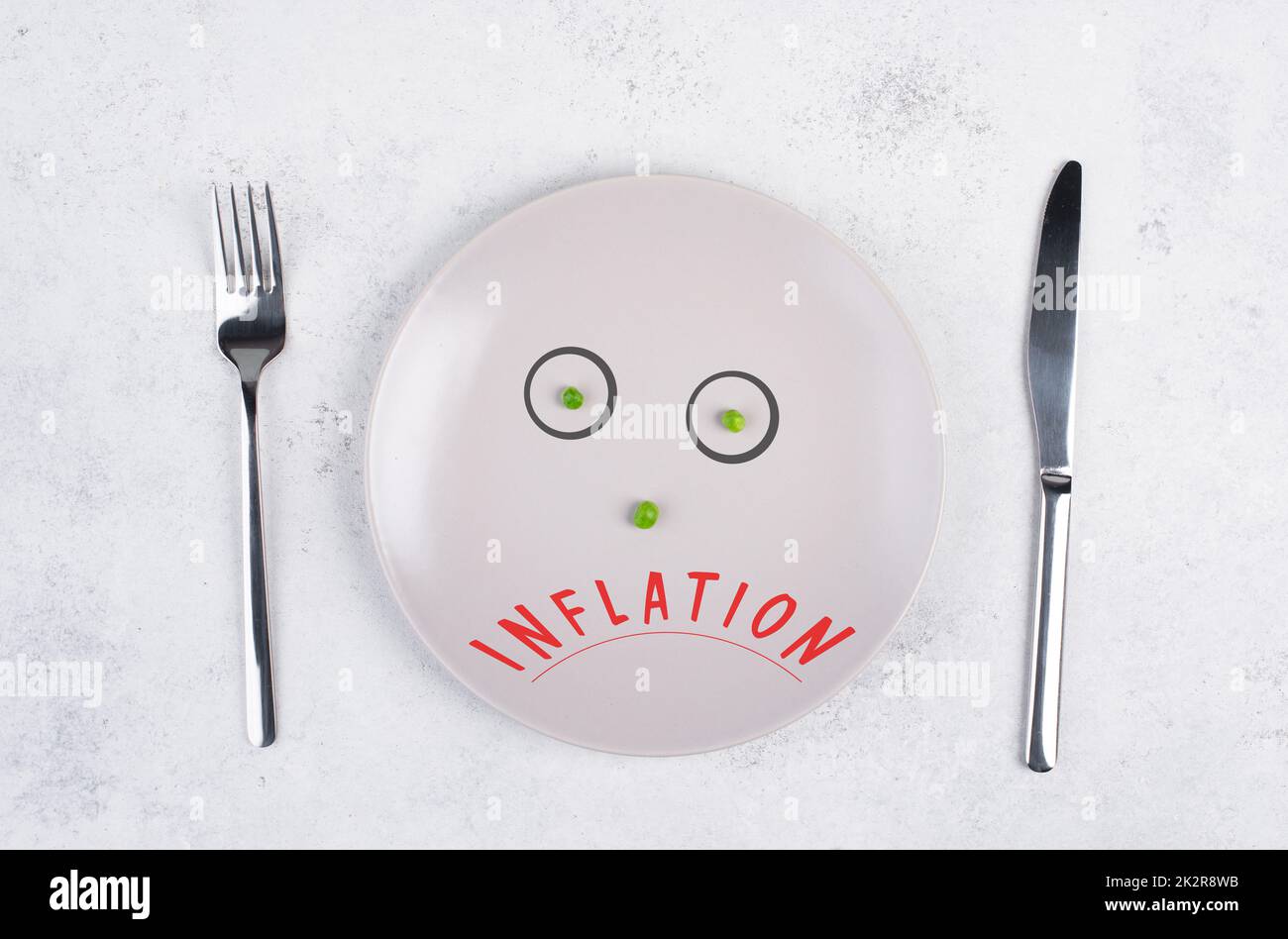 Inflation steht auf dem Teller, Nahrungsmittelknappheit und Hungersnot wegen des Krieges, der Hungersnot, des politischen Problems, mit grünen Erbsen konfrontiert Stockfoto Inflation steht auf dem Teller, Nahrungsmittelknappheit und Hungersnot wegen des Krieges, der Hungersnot, des politischen Problems, mit grünen Erbsen konfrontiert Stockfoto