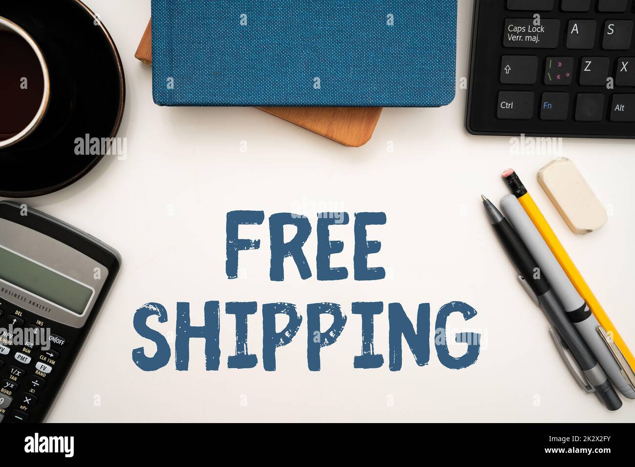 Textzeichen mit kostenlosem Versand. Geschäftsansatz Fracht Fracht Konsignation Fracht Fracht Fracht Fracht Fracht Fracht Fracht Fracht Fracht Fracht Fracht Fracht Versandkarton Bürobedarf über Schreibtisch mit Tastatur und Gläsern und Kaffeetasse für die Arbeit Stockfoto