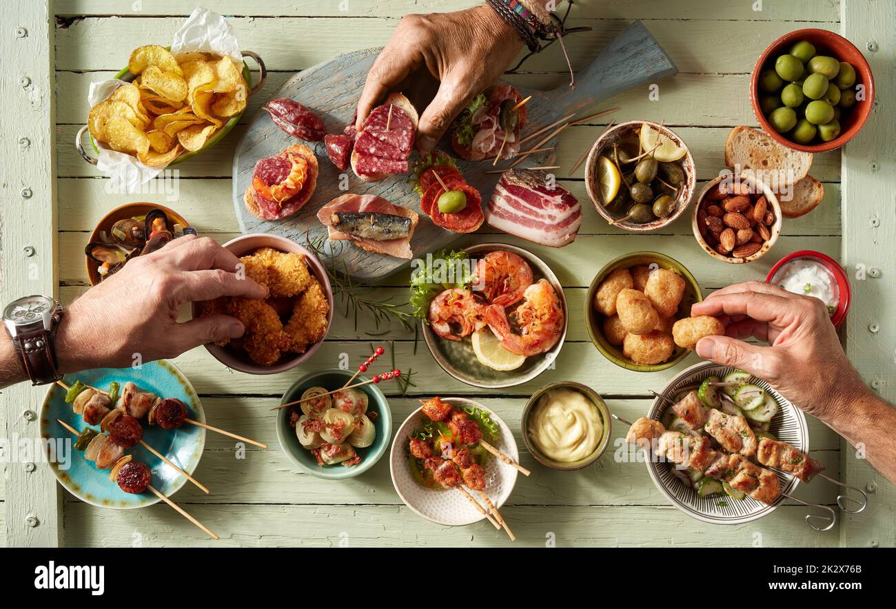 Nicht wiedererkennbare Leute, die verschiedene Snacks essen Stockfoto