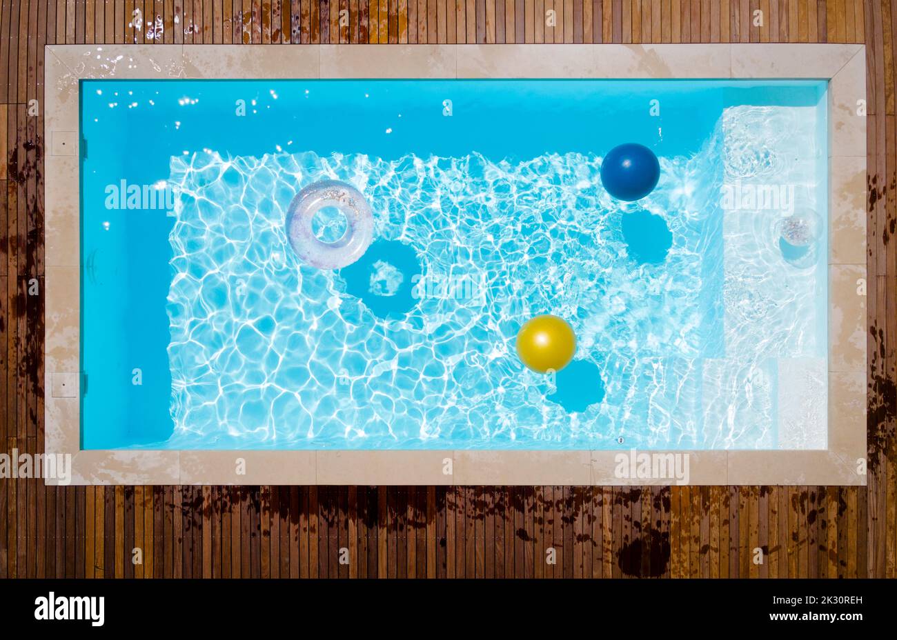 Aufblasbarer Ring und Ball schwimmend im Schwimmbad Stockfoto