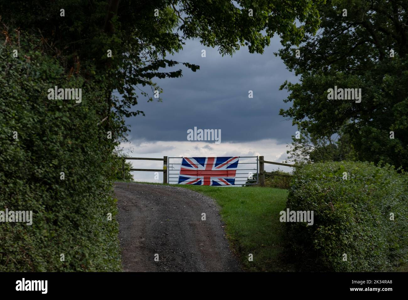 Die Union Jack-Flagge, die an einem Farmtor in der Landschaft von Worcestershire angebracht ist, zeigt den Glauben an die britische Monarchie. Stockfoto