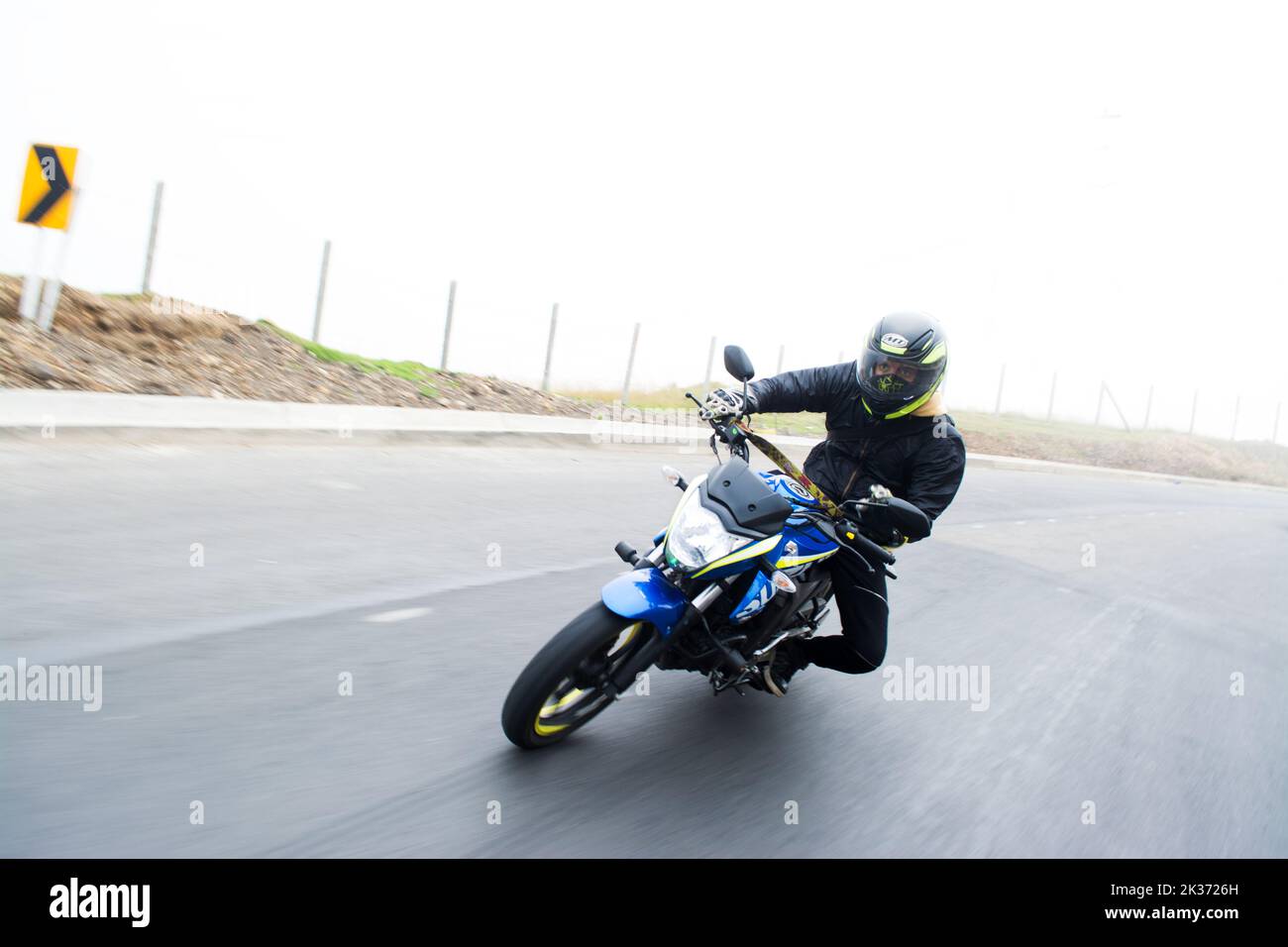 Ein junger Motorradfahrer auf einem Susuki-Fahrrad, der auf einer Straße fährt Stockfoto