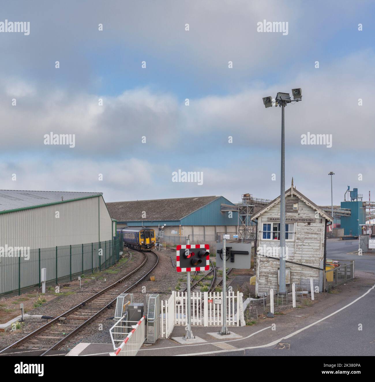 Dieselzug der East Midlands Railway Class 156, der das mechanische Stellwerk am Barrow Road Crossing in New Holland auf der Barton Line, Großbritannien, überquert Stockfoto