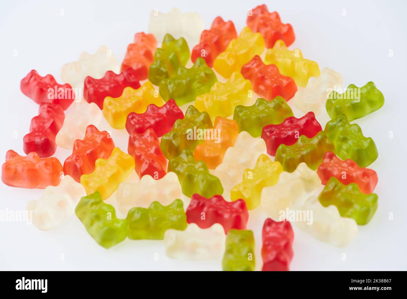 Rote, orange, weiße, grüne und gelbe Gummibärchen vor weißem Hintergrund Stockfoto
