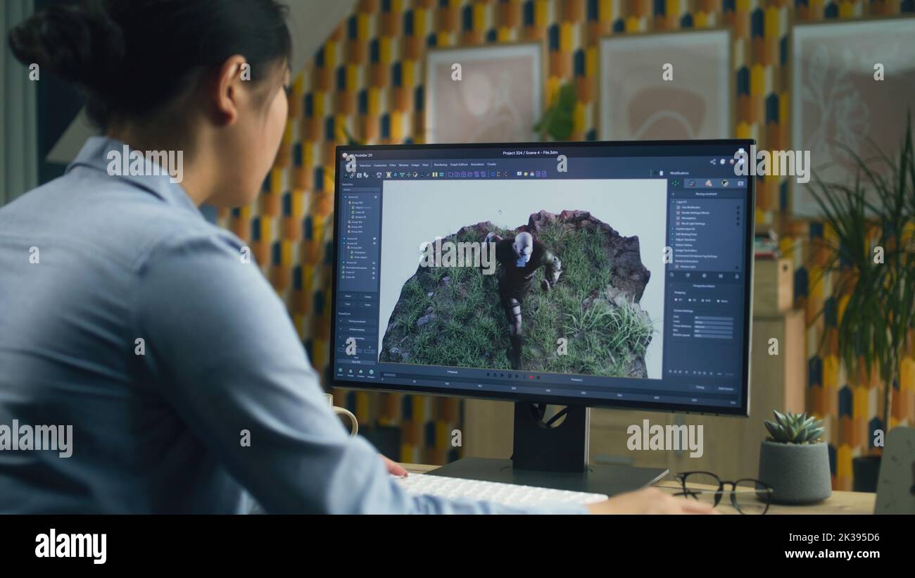 Asiatische weibliche 3D Designerin macht Animation für Videospiel-Charakter mit modernen Computer mit Software für die Erstellung von 3D Modellierungs-Projekte Stockfoto