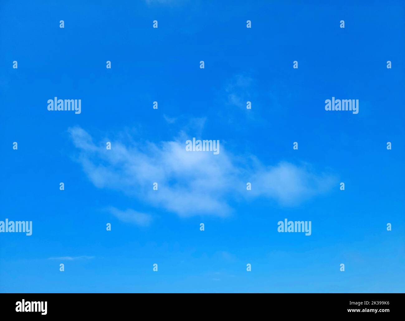 Eine einzelne wispy Wolke in einem strahlend blauen Himmel Stockfoto