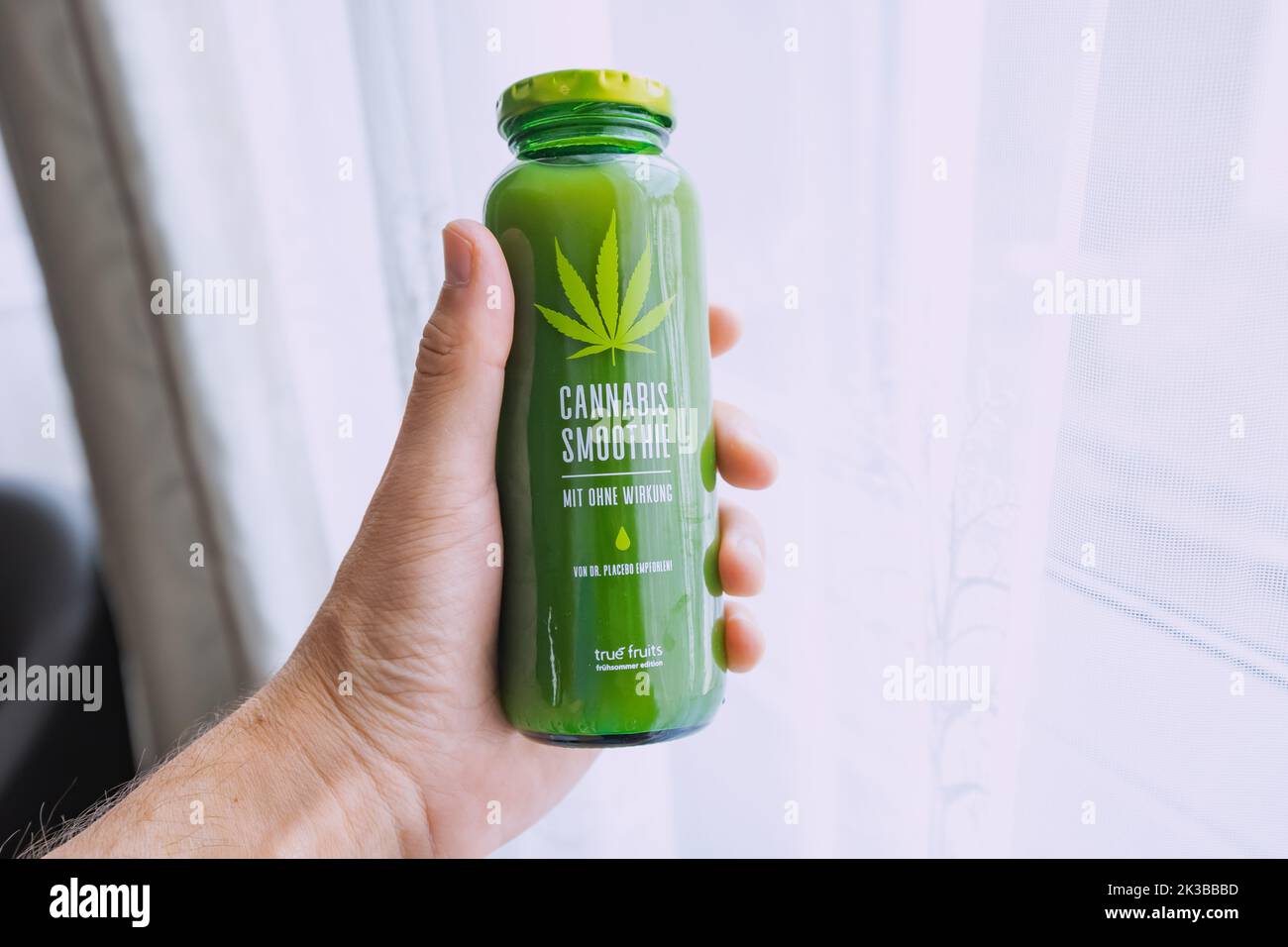 22. Juli 2022, Düsseldorf, Deutschland: Smoothie-Flasche mit Cannabis in der Hand. Dieser beliebte Köder für Touristen enthält keine verbotenen Substanzen und Cannabi Stockfoto