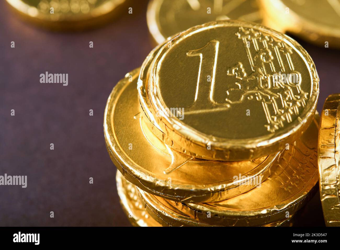 Schokoladenmünze. Hintergründe von Schokolade Euro-Münze Geld auf braunem Hintergrund. Euro-Münzen übereinander gestapelt in verschiedenen Positionen. Eine Gruppe von Münzen. Stockfoto