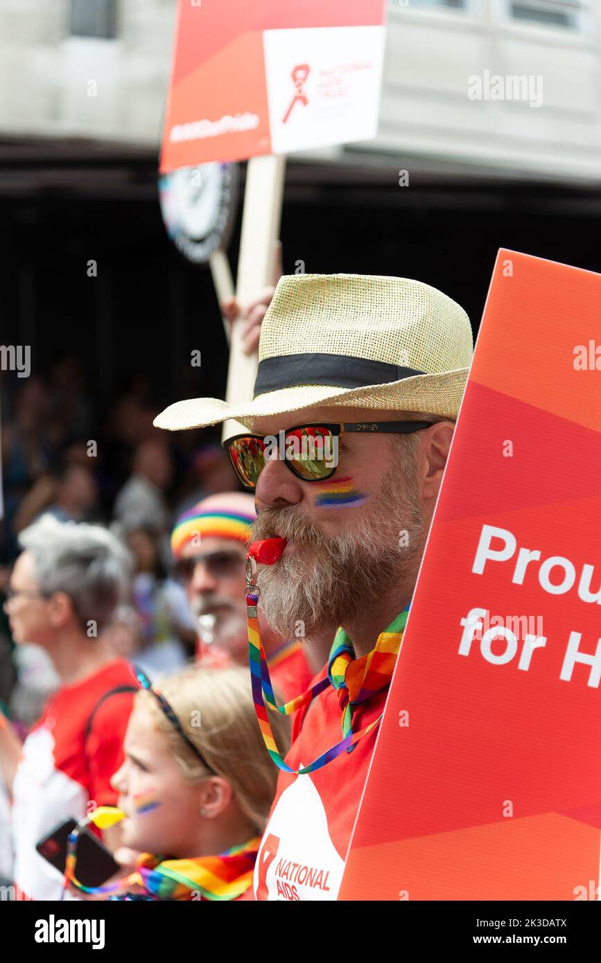 Ein vertikales Bild eines Marschers, der den National AIDS Trust auf der Straße repräsentiert Stockfoto