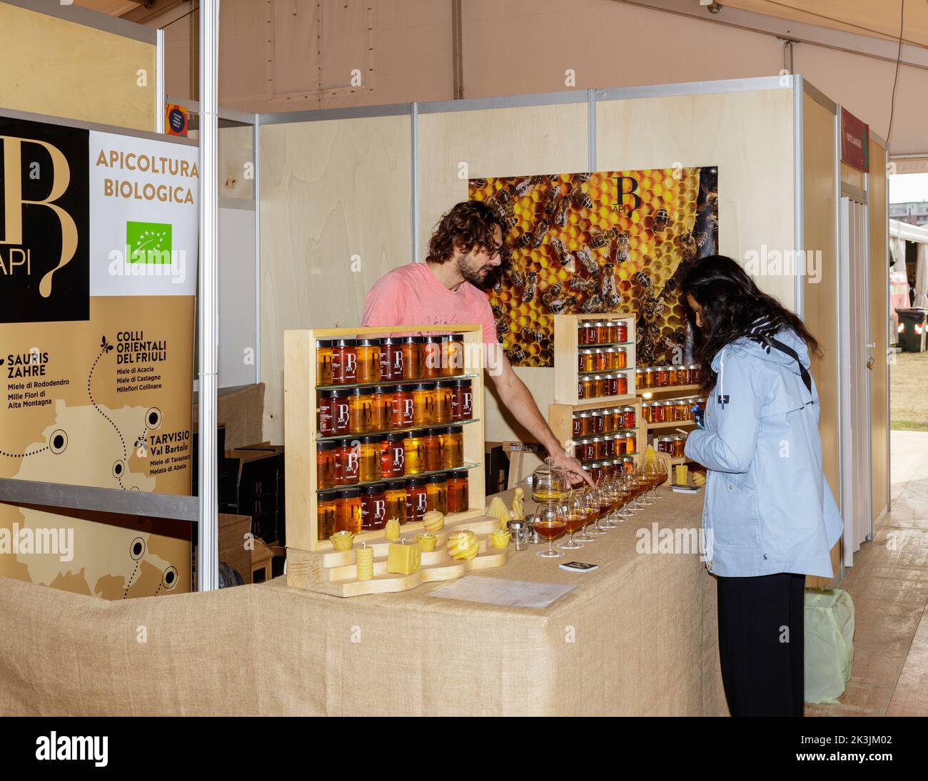 Turin, Italien - 23. September 2022: Während der Messe 'Terra Madre - Salone del Gusto' (kostenlose Veranstaltung), Honigverkäufer mit einem Kunden Stockfoto