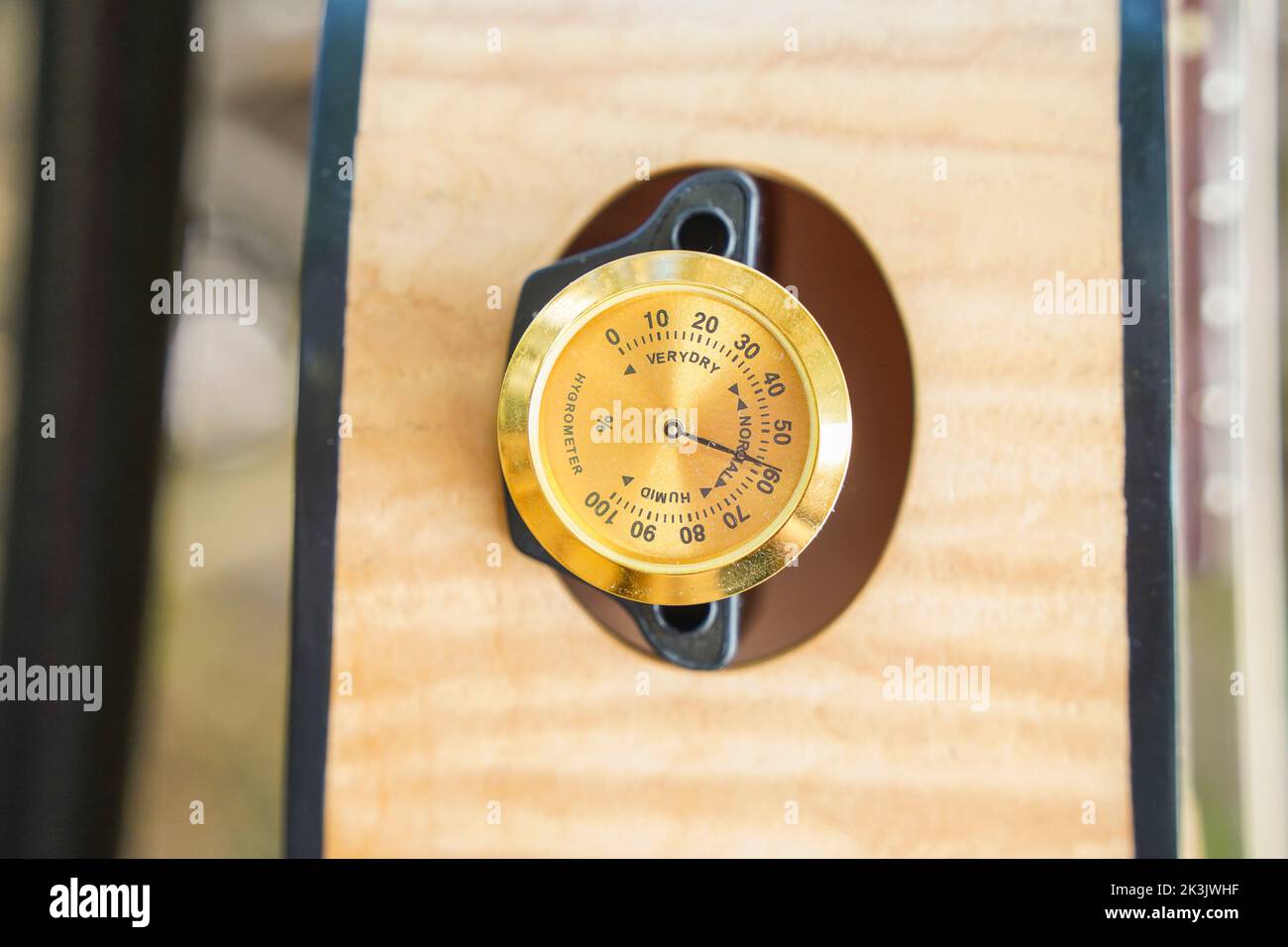 Gitarrenbefeuchter mit Hygrometer in einem Schallloch platziert. Stockfoto