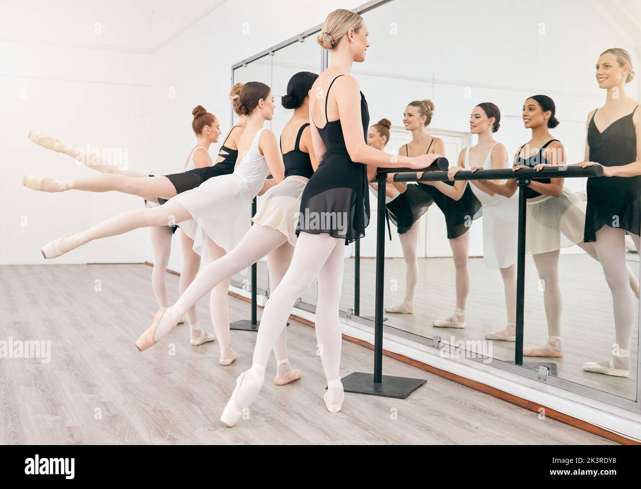 Ballettschülern und Spiegelbalance im Studio für die Übung zur Körperreflexion. Starke, gesunde und flexible Ballerina Athletenklasse Stretching Stockfoto