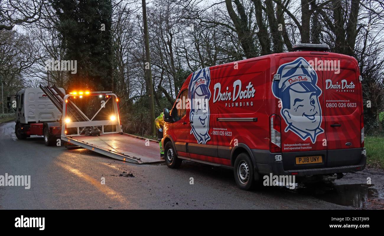 Ein kaputter Drain-Doctor-Van, der mit einem Abschleppwagen geborgen wird, Massey Brook, Lymm, Warrington, Cheshire, ENGLAND, GROSSBRITANNIEN, WA13 0PN Stockfoto
