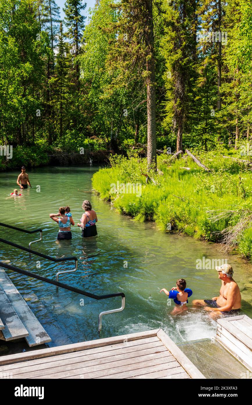 Touristen, die die heißen Quellen am Liard River, den Liard River Provincial Park, British Columbia und Kanada genießen Stockfoto