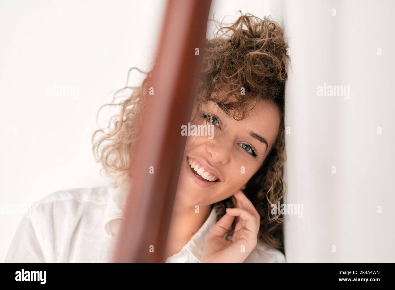 Lächelnde Frau mit lockigem Haar Stockfoto