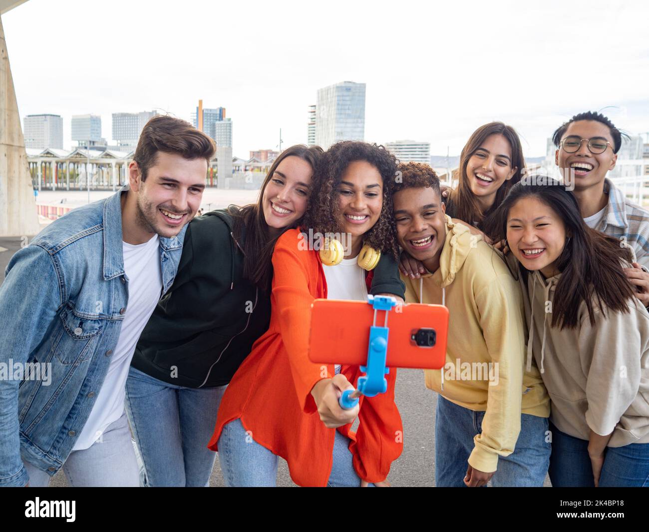 Eine Gruppe verschiedener Millennials, die ein Video aufnehmen oder ein Foto für soziale Medien machen. Junge Menschen, die Spaß mit neuer Technologie haben Stockfoto