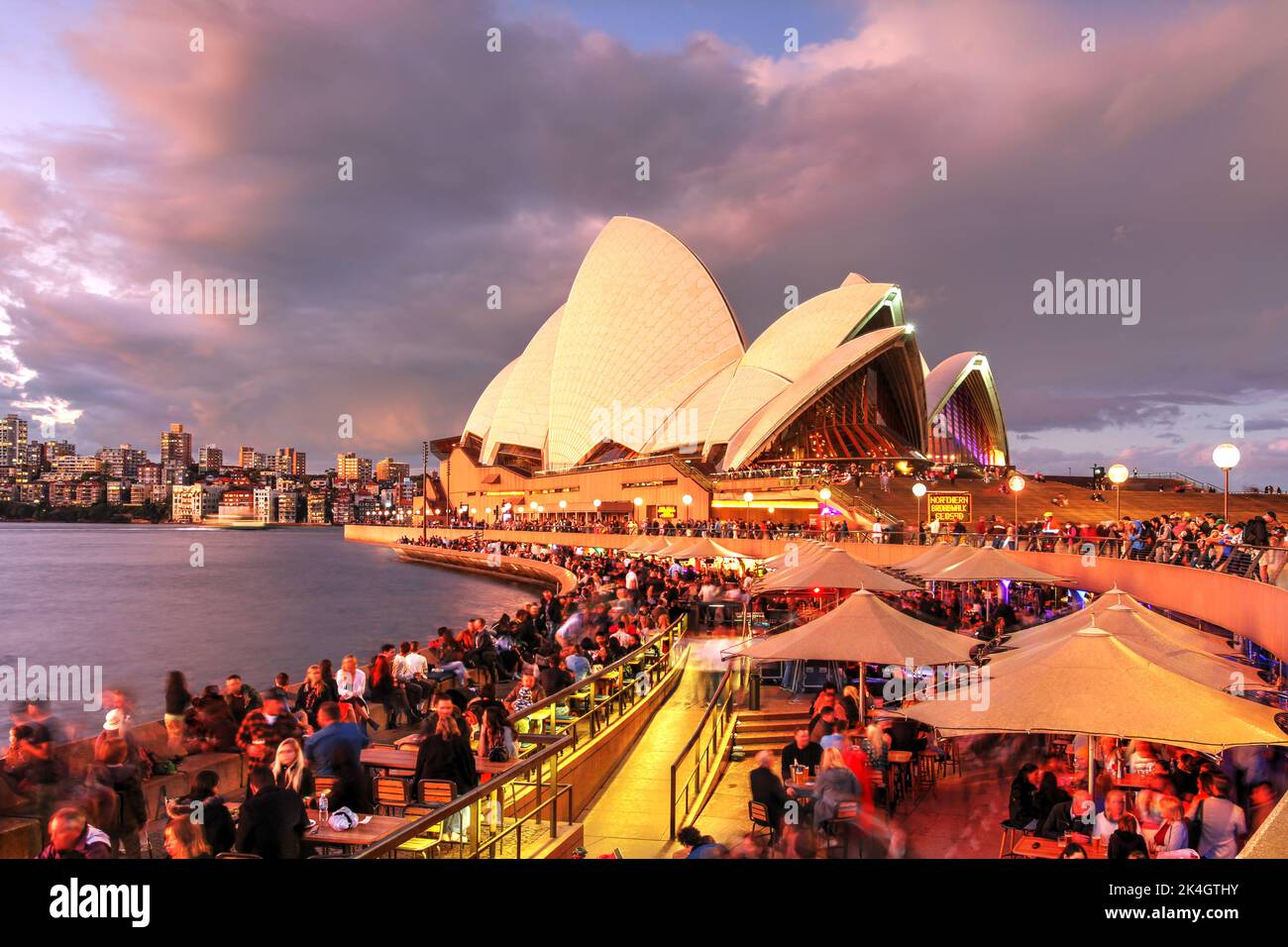 Während des lebhaften Festivals können Sie den herrlichen Sonnenuntergang über dem Opernhaus von Sydney genießen, während viele Menschen auf die Beleuchtung warten. Stockfoto