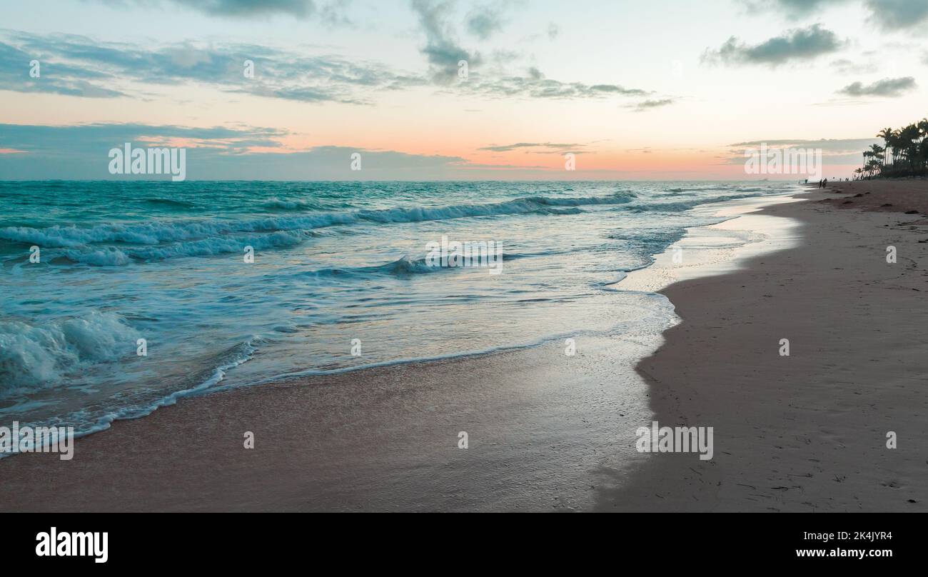 Dominikanische Küstenlandschaft mit leerem Sandstrand und Wellen am Morgen. Dominikanische republik. Bavaro Strand Stockfoto